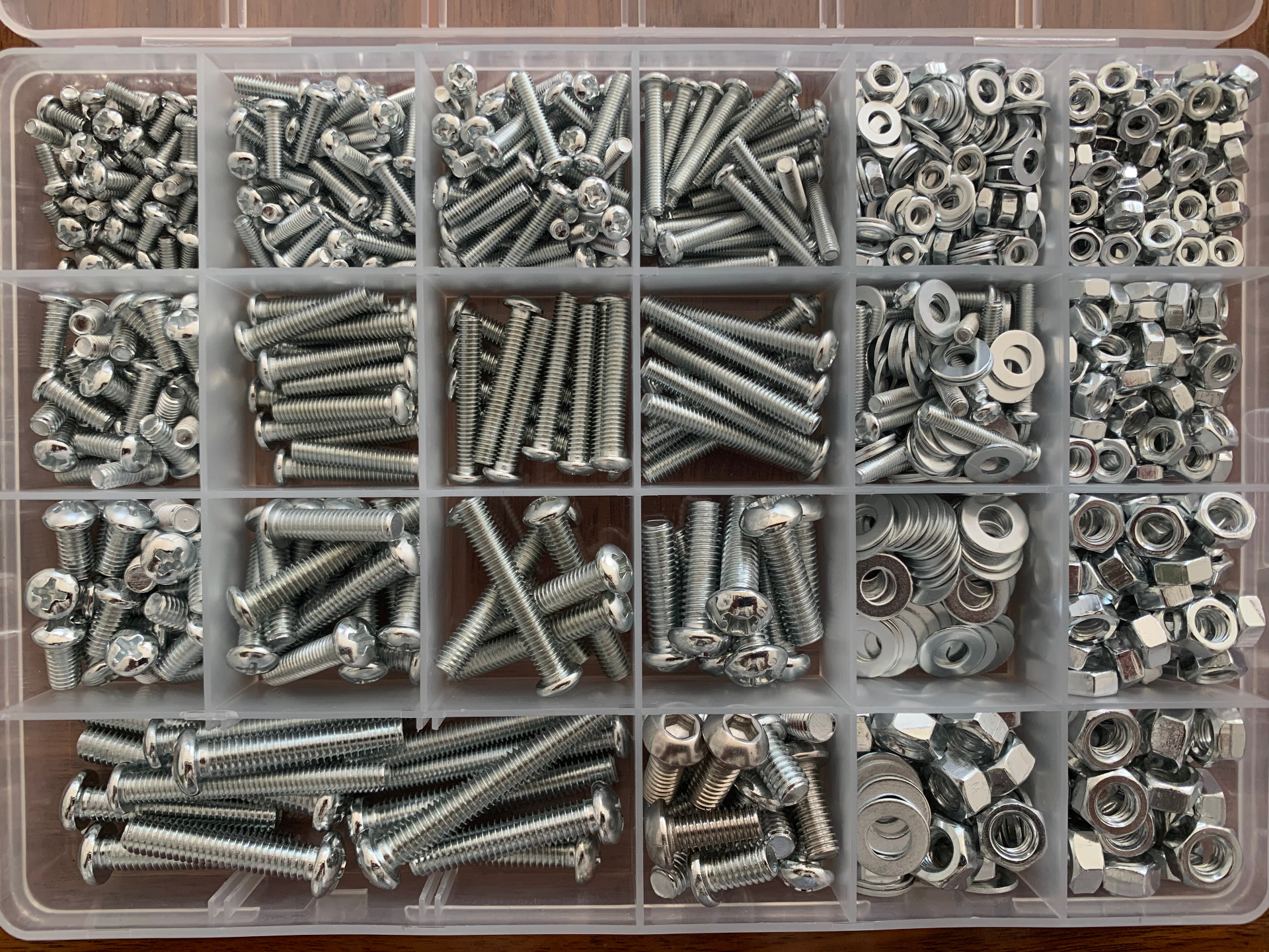 Organizer box with many compartments of assorted screws, nuts and washers